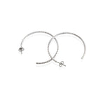 A pair of sterling silver textured hoop earrings with a rhodium-based anti-tarnish coating.