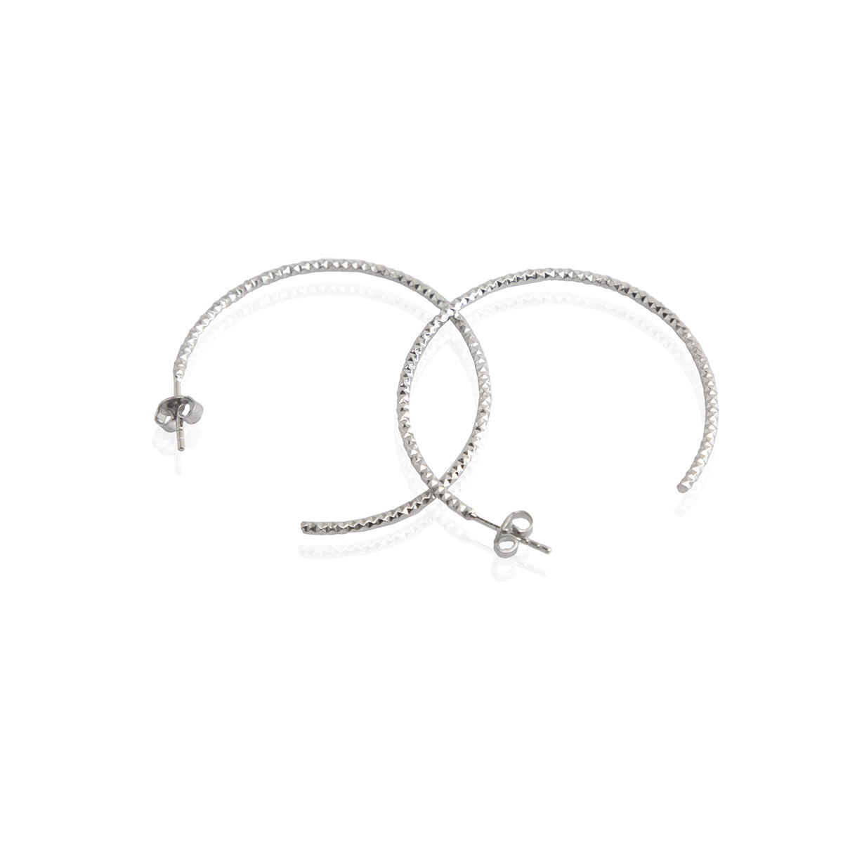 A pair of sterling silver textured hoop earrings with a rhodium-based anti-tarnish coating.