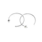 A pair of sterling silver textured hoop earrings with a rhodium-based anti-tarnish coating.