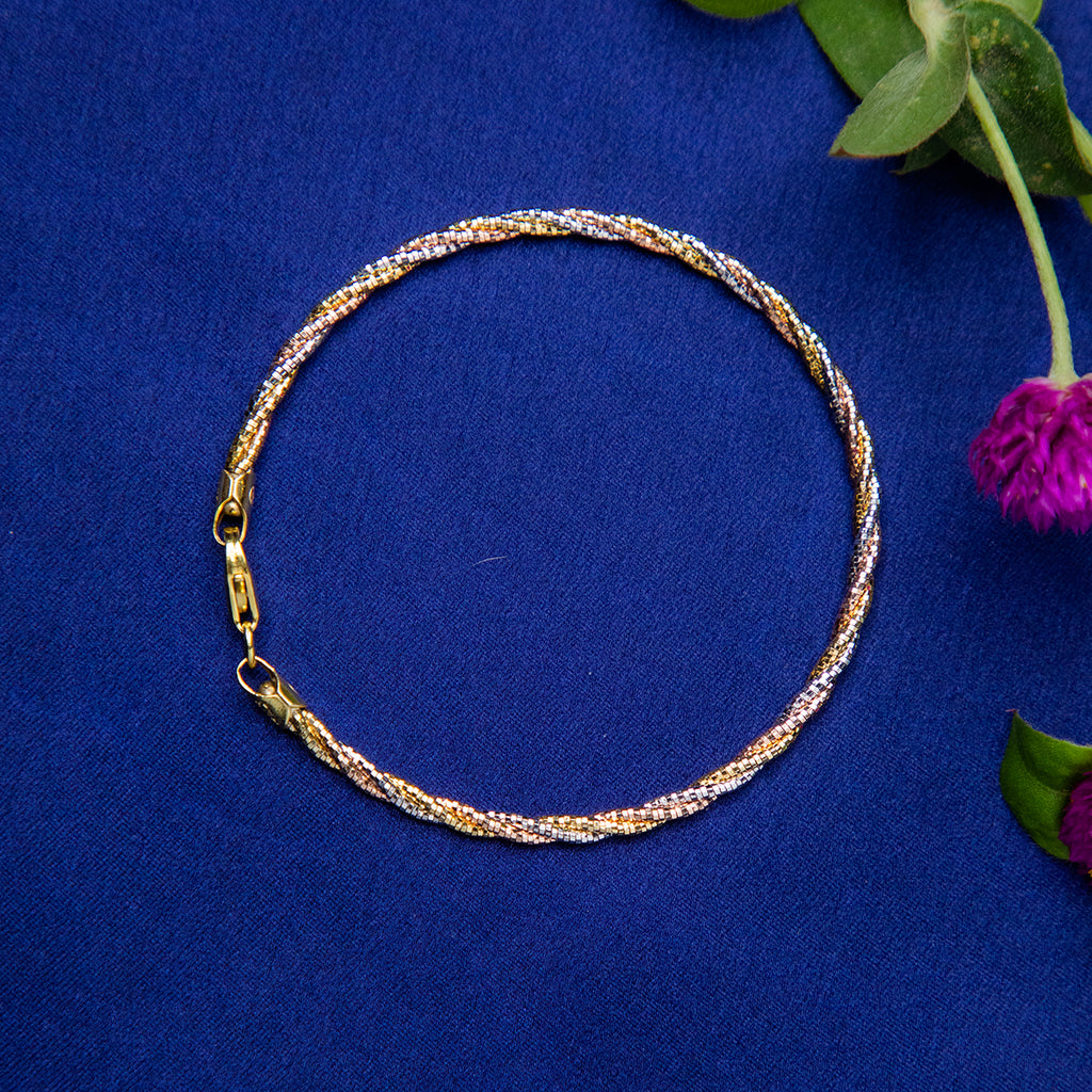A twisted silver bracelet displayed on a blue background with a floral accent.