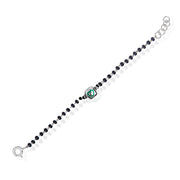A sterling silver bracelet for kids featuring a green heart charm and black and white beads. Perfect for gifting